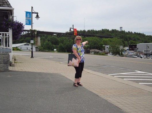 woman tourist pointing to tower on a distant hill